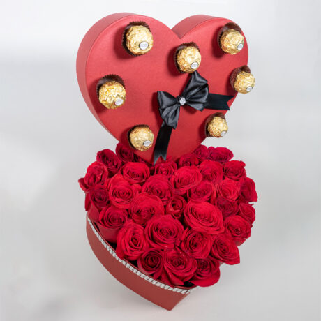 caja de rosas rojas en forma de corazon con chocolates ferrero rocher y moño negro
